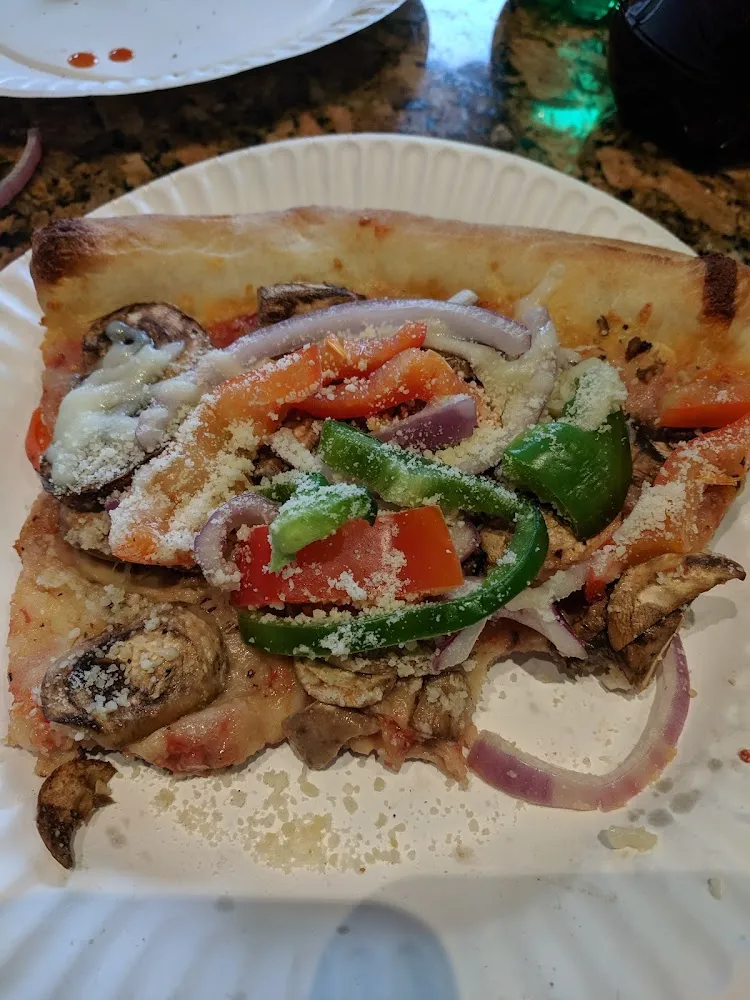 A Slice of Peppers Onions Mushrooms with Parmesan Cheese Sprinkled On